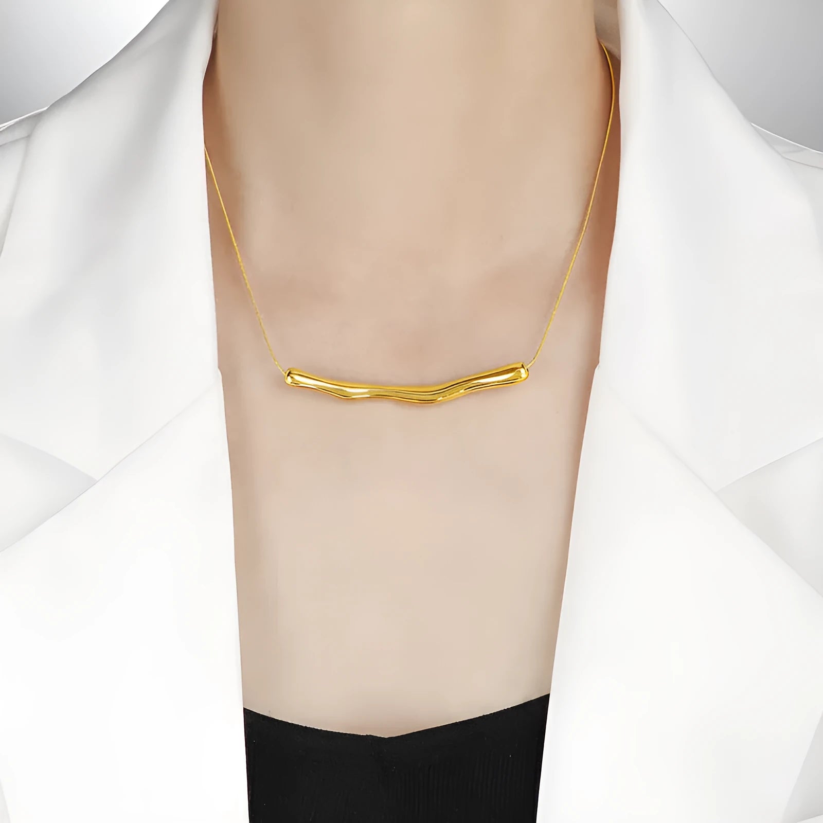 Close-up of a women's titanium steel necklace with an irregular pleated texture, shown in a gold tone finish.