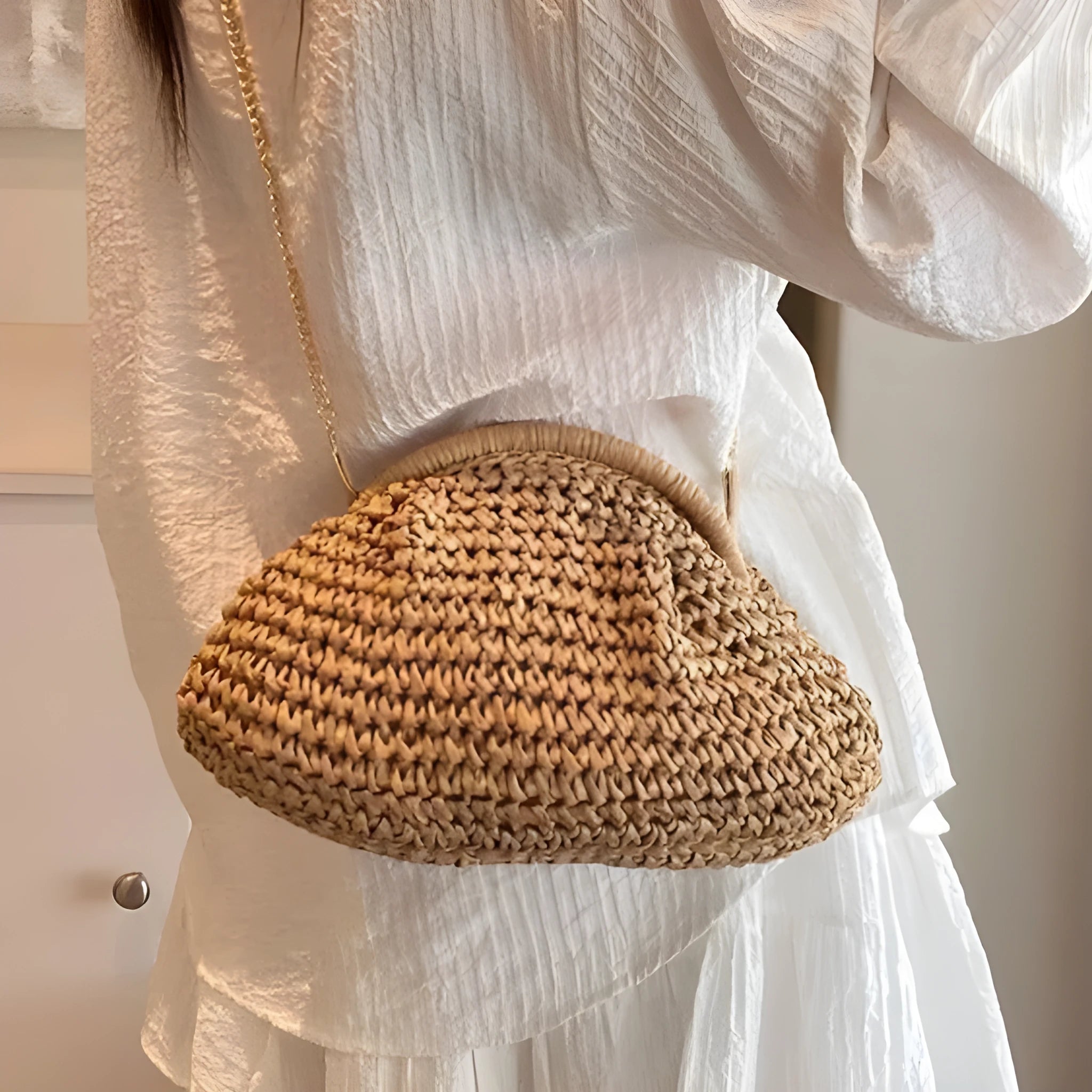 Women's khaki paper straw shoulder bag with a chain strap and shell shape.