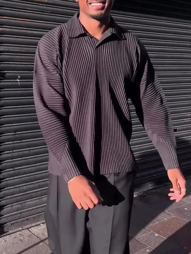 Black men's long-sleeved casual top with pleated detail on the front.