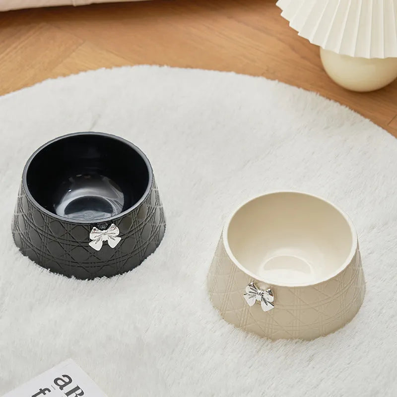 Decorative pet bowl with bowknot and diamond pattern in pink, silver, black, purple, and white colours.
