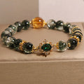 Women's gold rutilated quartz crystal bracelet with green phantom quartz beads and pearl rhinestone accents