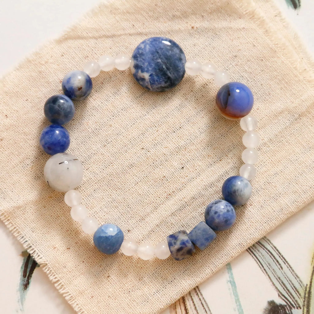 Hand-woven natural stone bracelet with blue point stone and black hair crystal agate in geometric design