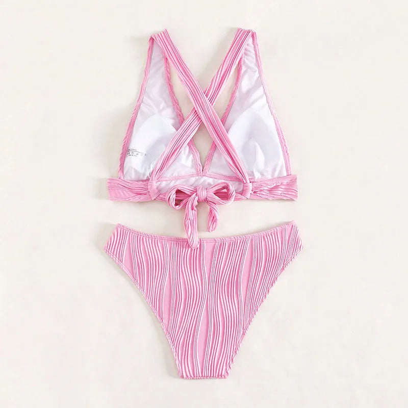 Women's pink halter strap bikini swimsuit with matching shorts on a mannequin
