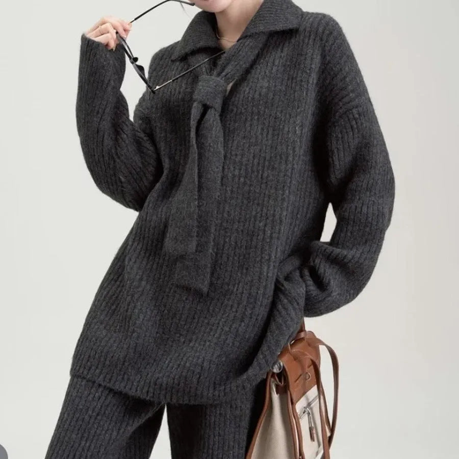 Dark grey sweater suit two-piece set with knit top and trousers showing collage stitching detail