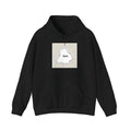 Man wearing a black loose-fit drop-shoulder hoodie with a front kangaroo pocket.