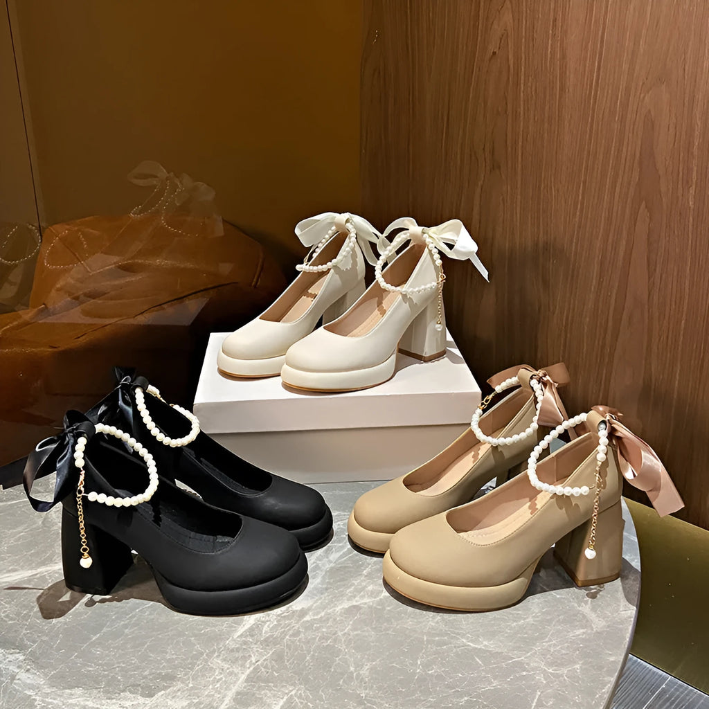 Beige women's Mary Jane shoes with a chunky heel, round toe, and pearl-decorated ankle strap buckle on a white background.