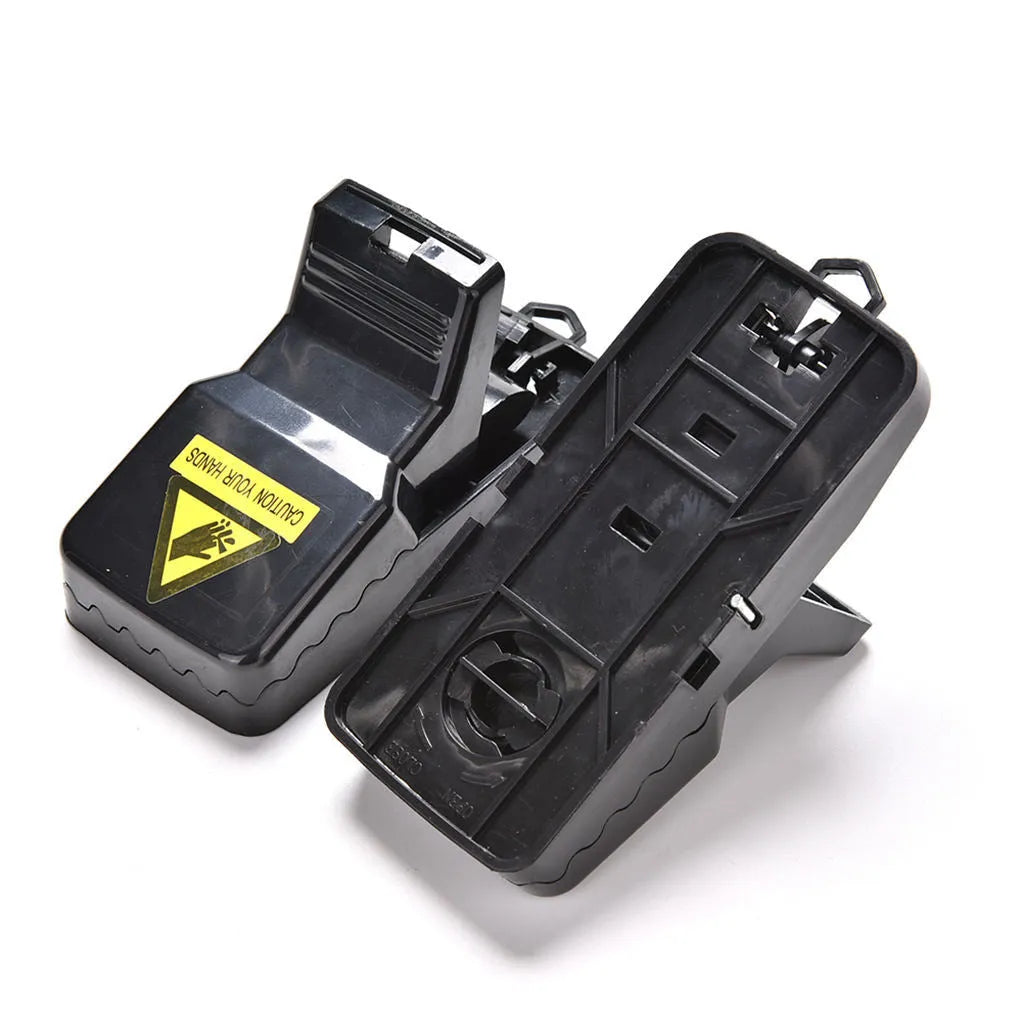 Six black plastic snap mousetraps showing smooth surface and compact size