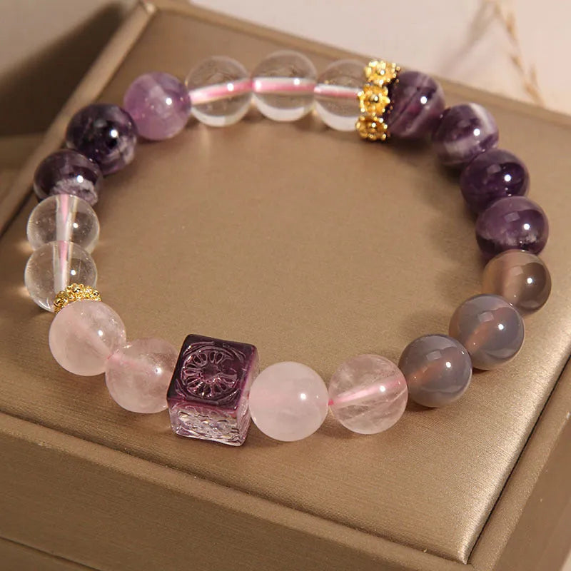 Women's purple amethyst crystal bracelet with rhinestone accents showing 10mm stones