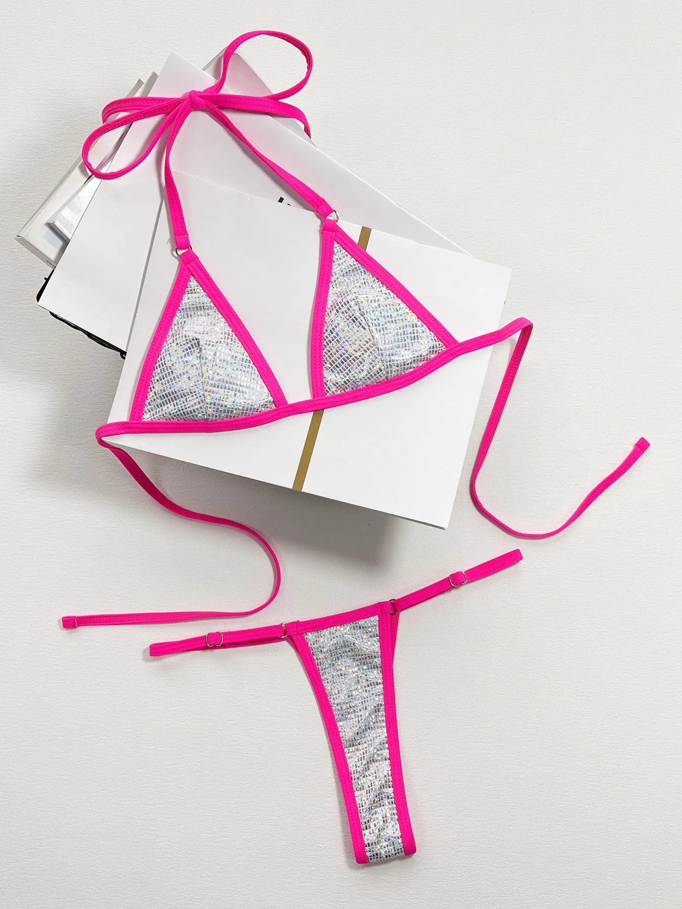 Solid silver women's triangle cut bikini swimsuit on a neutral background