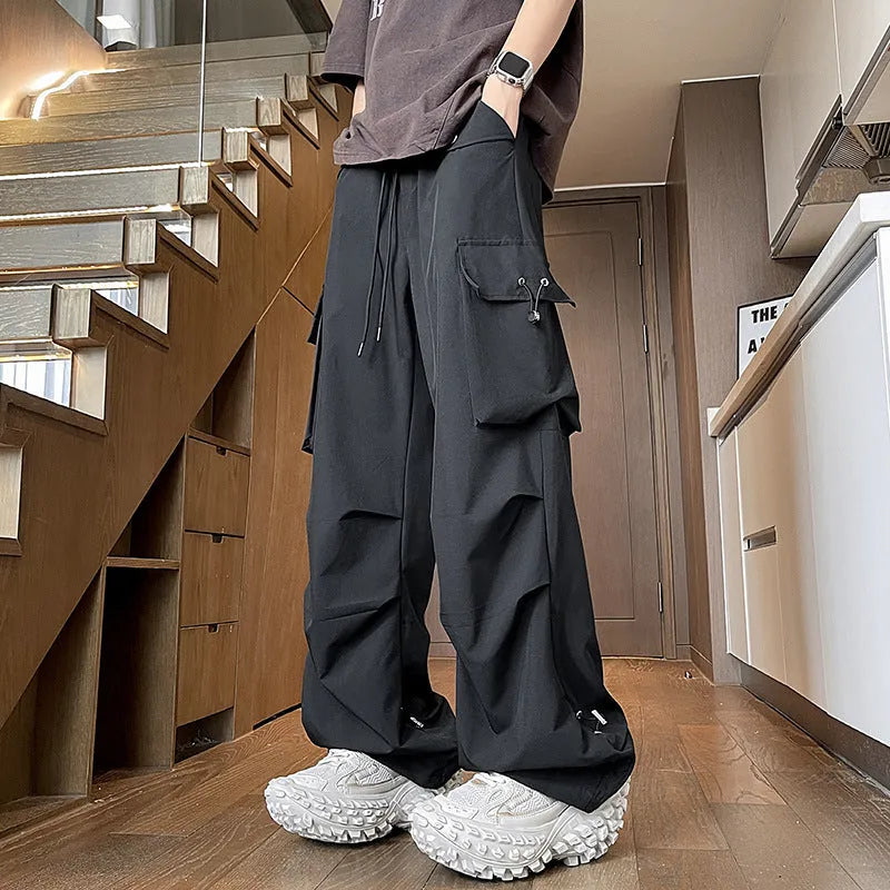 Waterproof loose-fit straight-leg trousers in black, available in plus sizes.