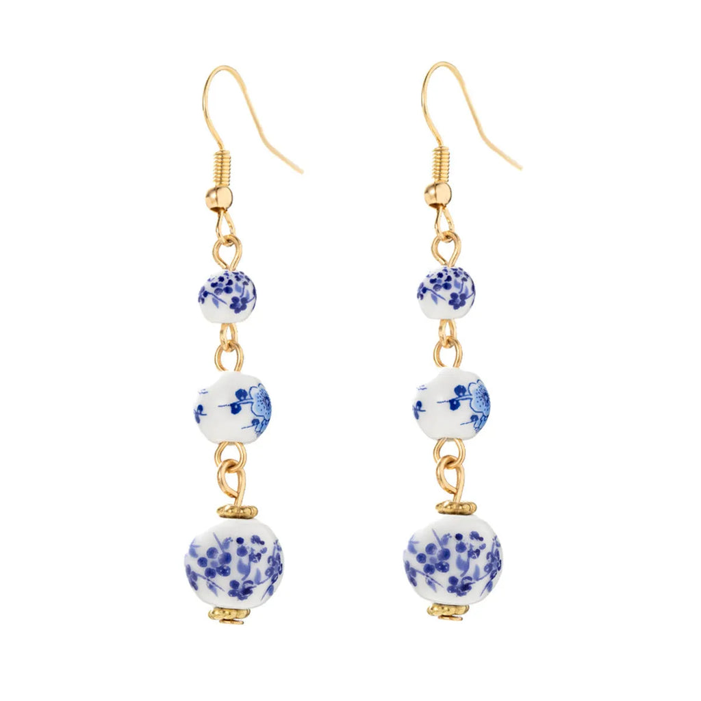 Long blue and white porcelain ceramic bead retro geometric earrings with alloy electroplated frame.