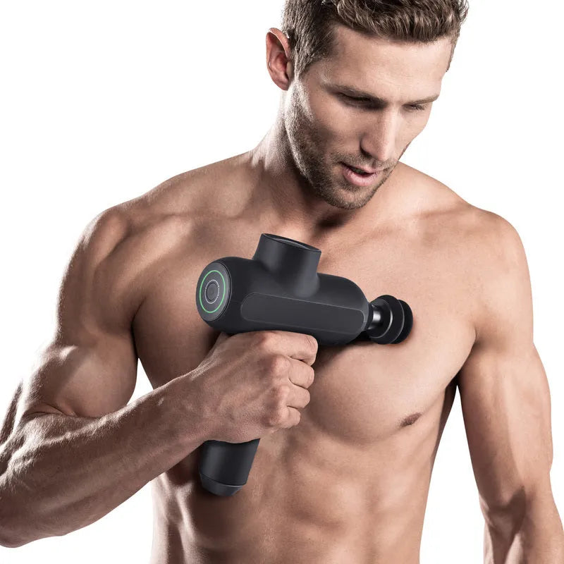 Rechargeable black percussion massage gun with six different coloured massage heads on a grey background.