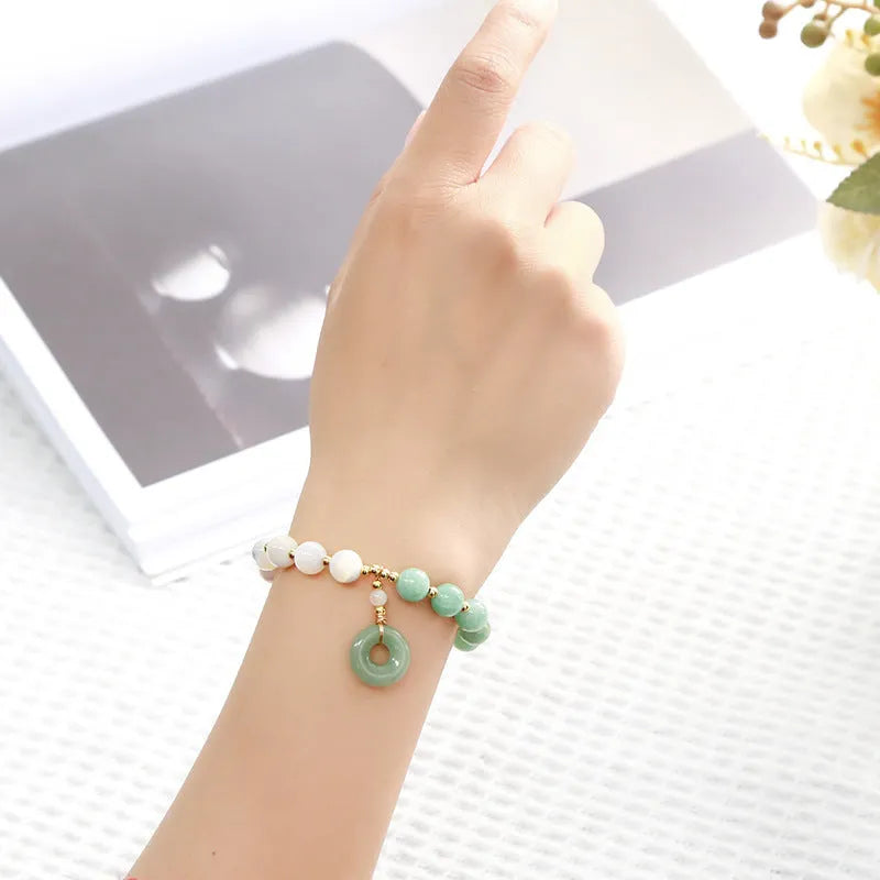 Blue Burma jade bracelet with 8mm round beads and a silver safety buckle clasp.