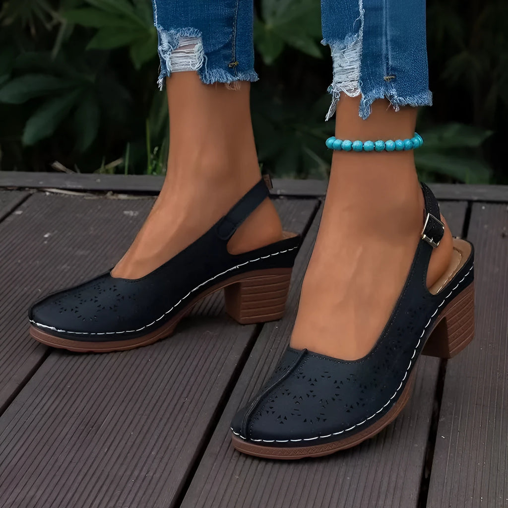 Women's black closed toe wedge sandals with round toe and rubber sole on a neutral background.