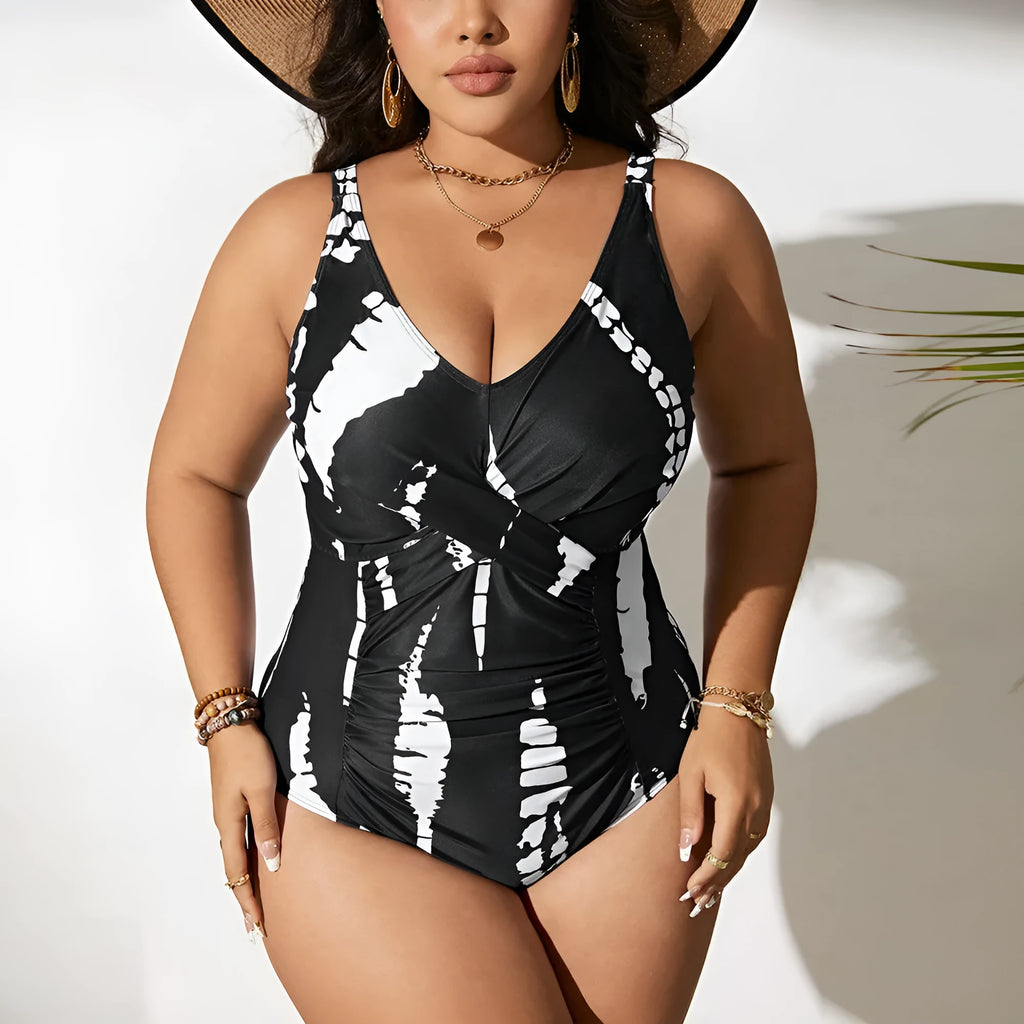 Black plus size one-piece swimsuit on a hanger, showing sleeveless conservative design.