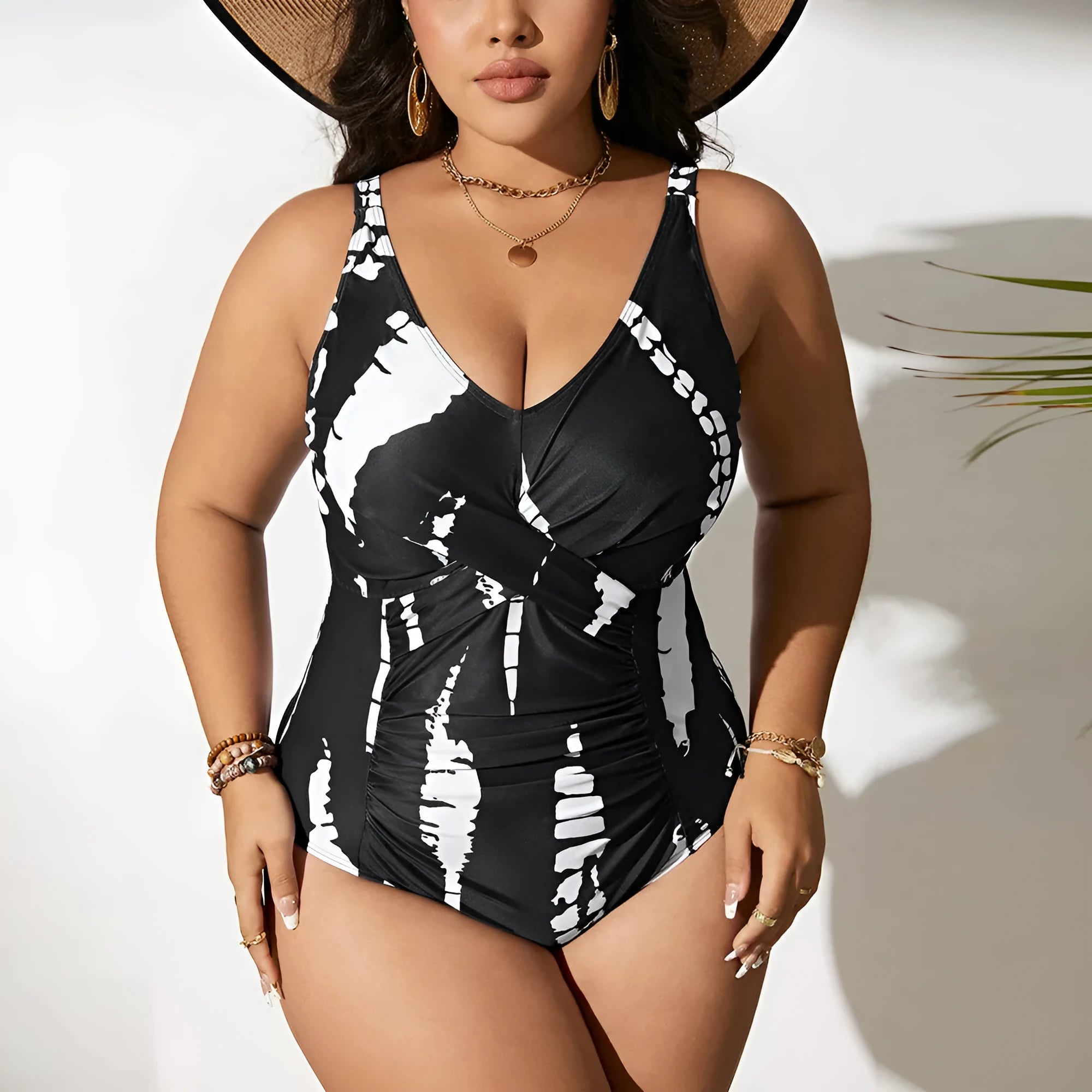 Black plus size one-piece swimsuit on a hanger, showing sleeveless conservative design.