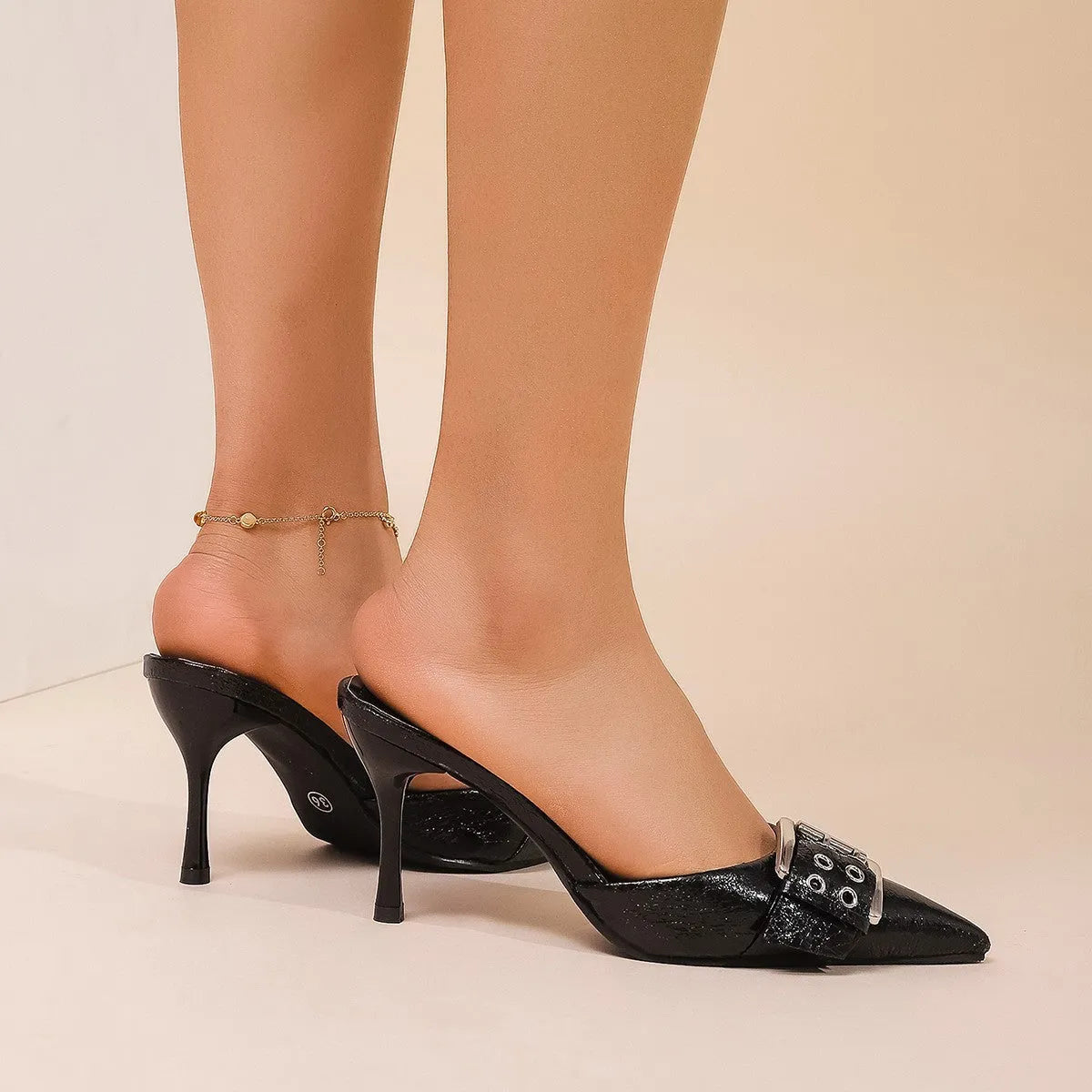 Black women's pointed toe high heels with adjustable ankle strap and decorative buckle fastening