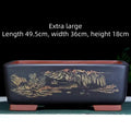 Large rectangular handmade purple clay flower pot in wine red, shown next to a bonsai tree.