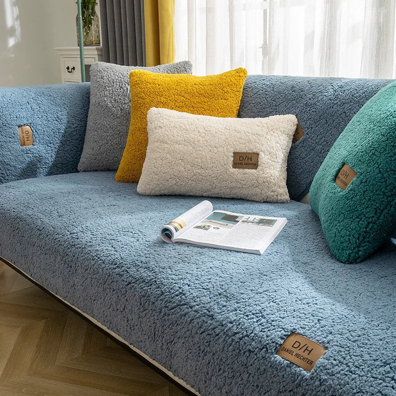Beige plush sofa cover with anti-slip backing draped over a living room sofa cushion.