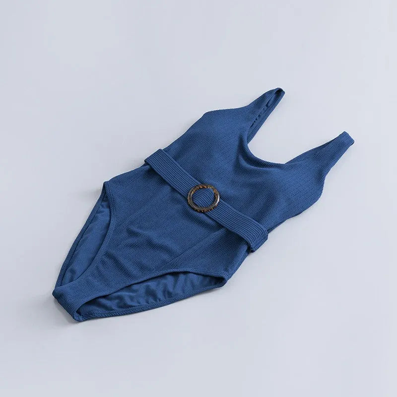 Women's navy blue one-piece swimsuit with triangle neckline and built-in chest padding