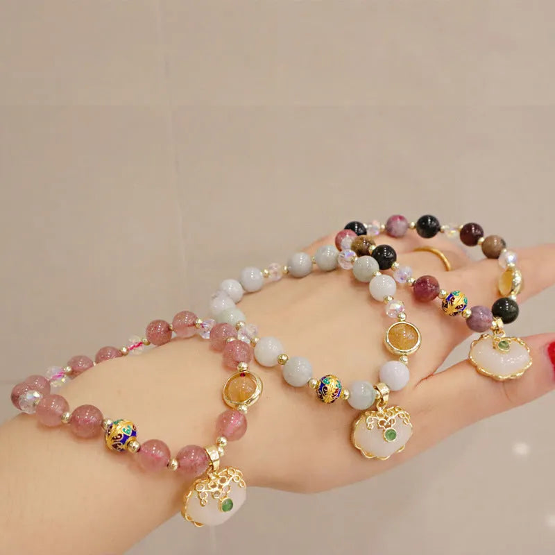 Women's ethnic bracelet with grey jade beads, strawberry quartz stones and geometric metal decorations