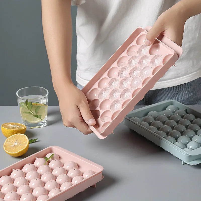 Sky blue and pink 3D round ice ball mould trays with 18 and 33 grid options for home bar use.