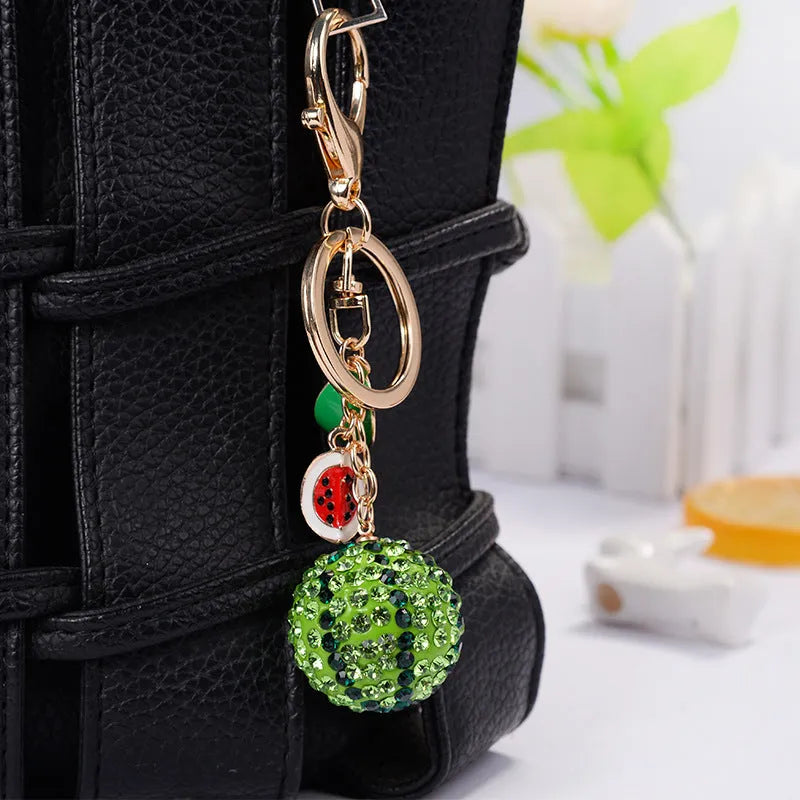 Green watermelon-shaped zinc alloy keychain measuring 12cm with textured surface details
