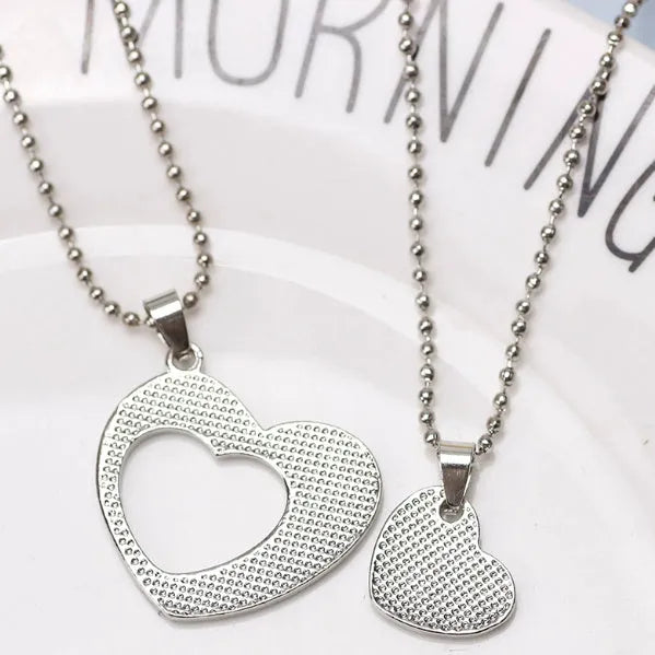 Two-piece silver alloy necklace set with heart-shaped pendants and cross chains in a love design
