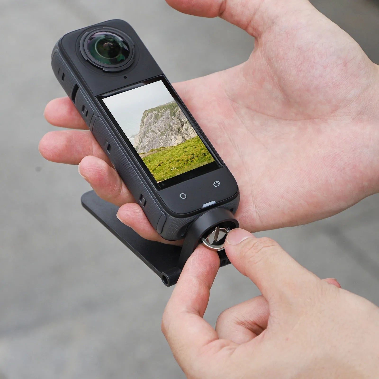 Black plastic magnetic desktop bracket and handle for Insta360 X4 action camera.