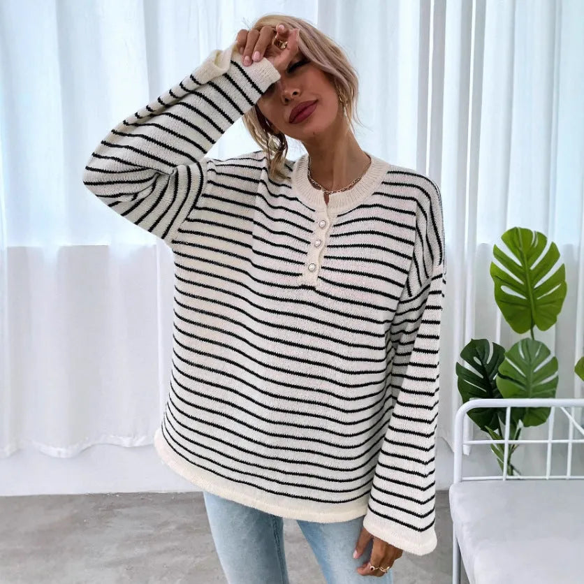 Black and white striped women's long-sleeve viscose top with drop-shoulder sleeves and a button detail.