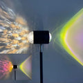Sunset red floor lamp projecting a water wave light pattern on a living room floor.