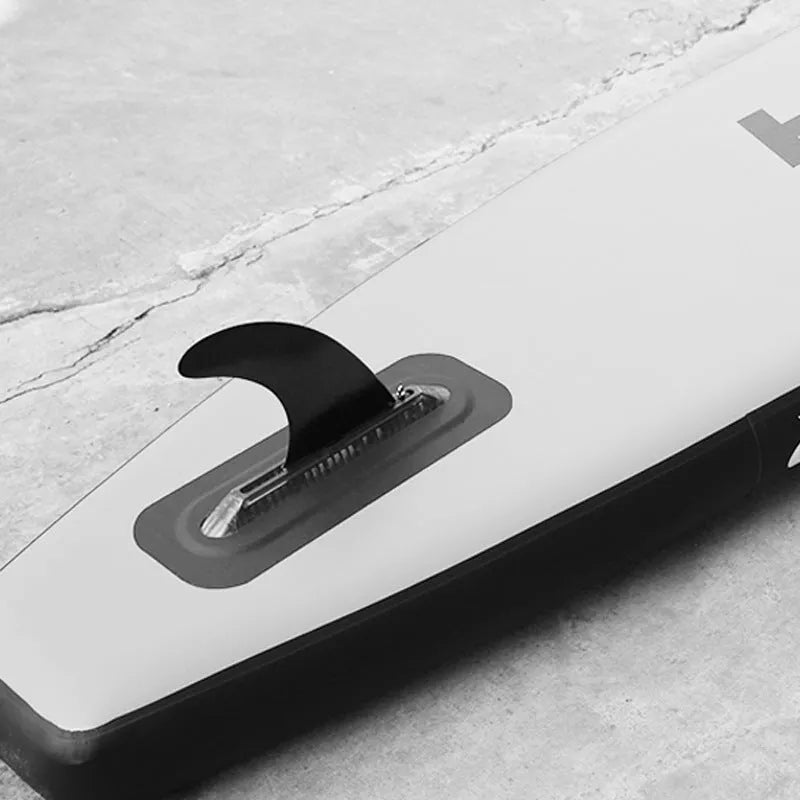 SUP paddle with detachable fish fins showing screw attachment mechanism and plastic construction