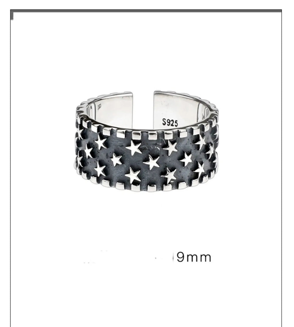 Adjustable sterling silver ring with engraved five-pointed star geometry patterns on a hand