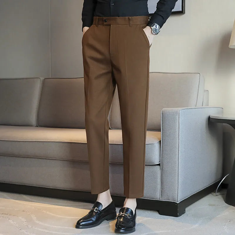 Straight leg brown corduroy trousers with an elasticated waistband on a hanger.