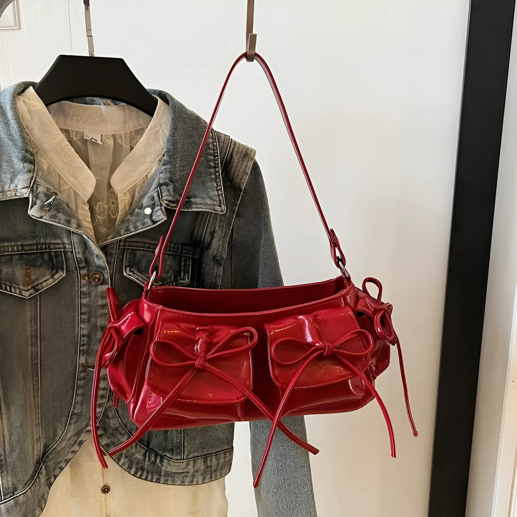Women's tassel bow shoulder bag showing pleated design and multiple pockets, available in eight colours