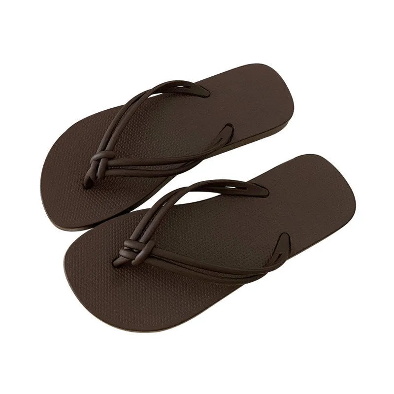 PVC women's flip flops in pink with a non-slip sole and toe-covering strap.