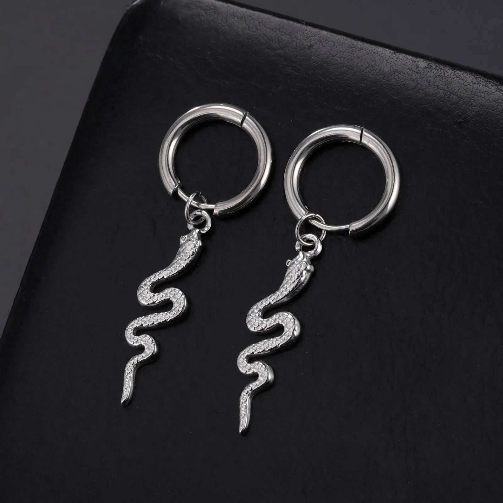 Gold plated stainless steel snake-shaped vintage earrings with detailed scale patterning and clip back closure