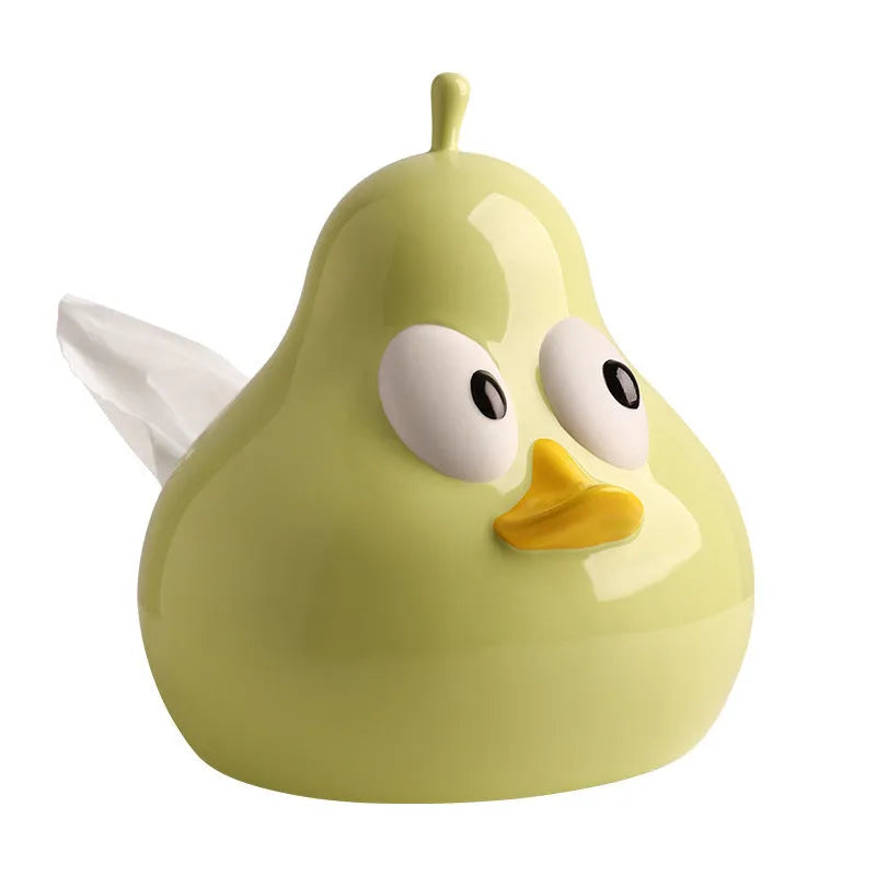 Green ceramic pear tissue box with animal style design on a wooden desktop