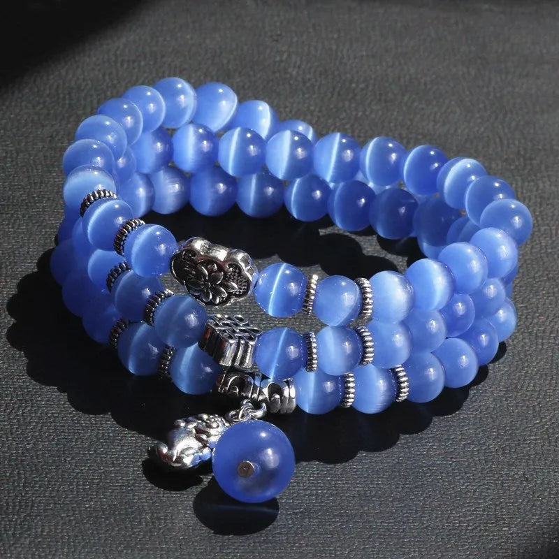 Opal crystal three-ring bracelet with geometric shapes and cat eye detailing in blue colour option
