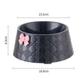 Decorative pet bowl with bowknot and diamond pattern in pink, silver, black, purple, and white colours.