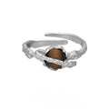 Women's adjustable Saturn open ring in electroplated white gold colour showing original design and adjustable opening mechanism