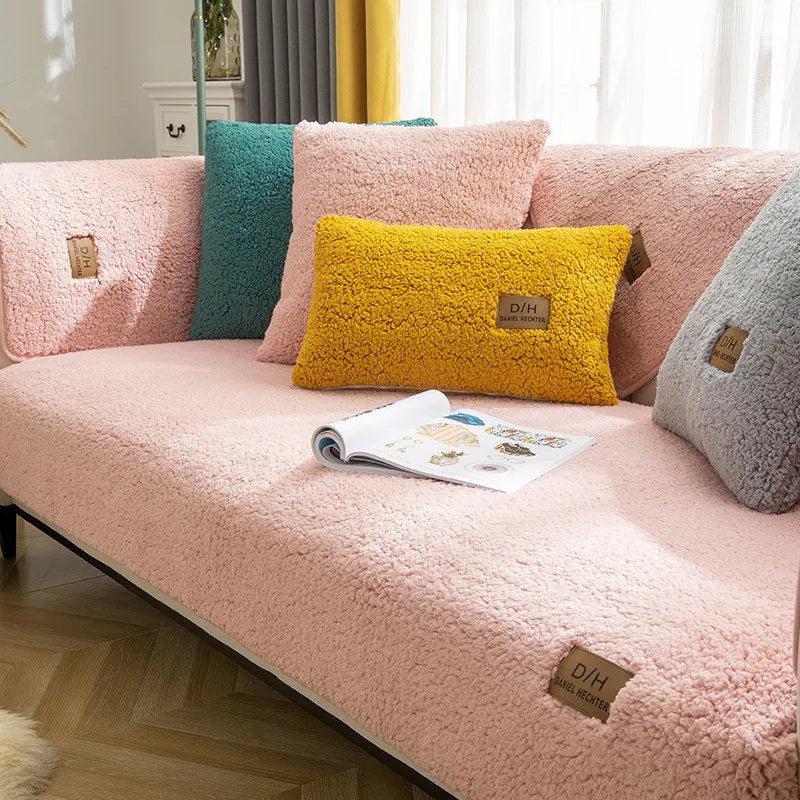 Beige plush sofa cover with anti-slip backing draped over a living room sofa cushion.