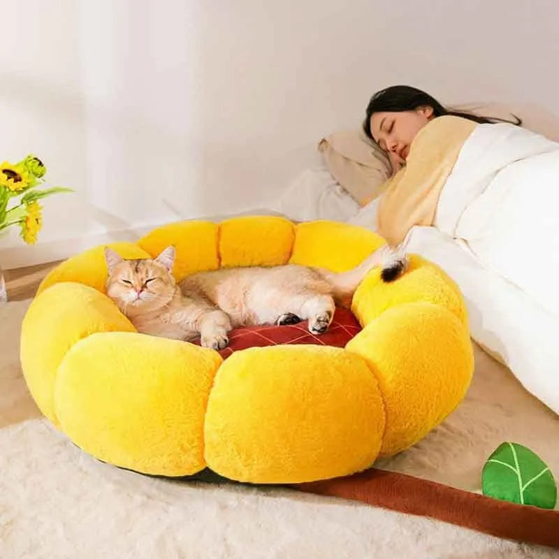 Soft yellow sunflower patterned pet nest cushion for cats and small dogs on a wooden floor.