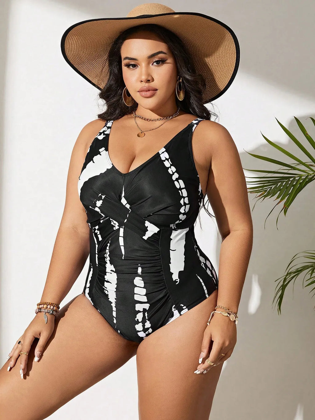 Black plus size one-piece swimsuit on a hanger, showing sleeveless conservative design.