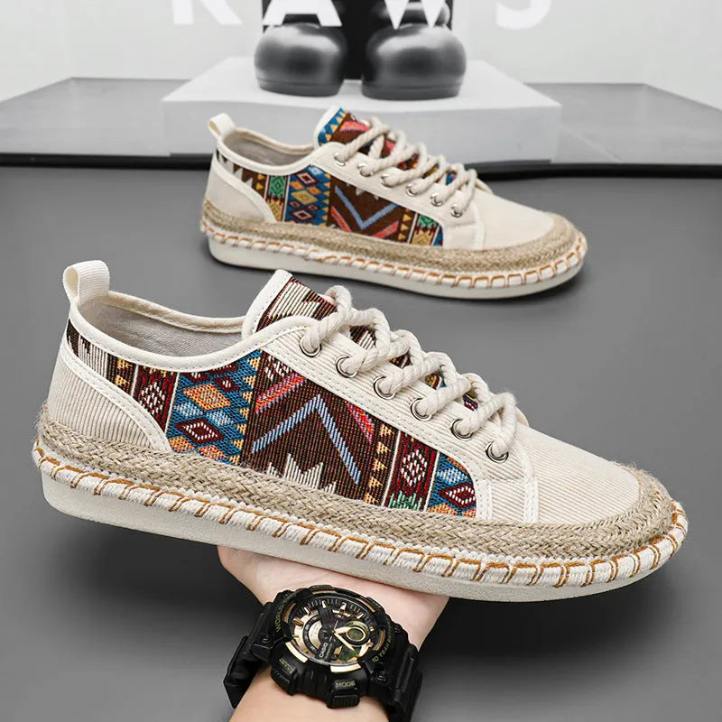 Men's round toe casual cloth shoes in beige and black on a plain background.