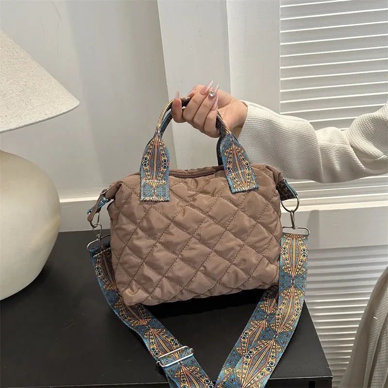 A soft oxford cloth shoulder messenger bag in a horizontal square shape with a single strap.