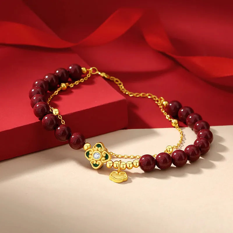 Women's geometric sterling silver bracelet with Ruyi, Xiangyun and red cinnabar flower detailing.
