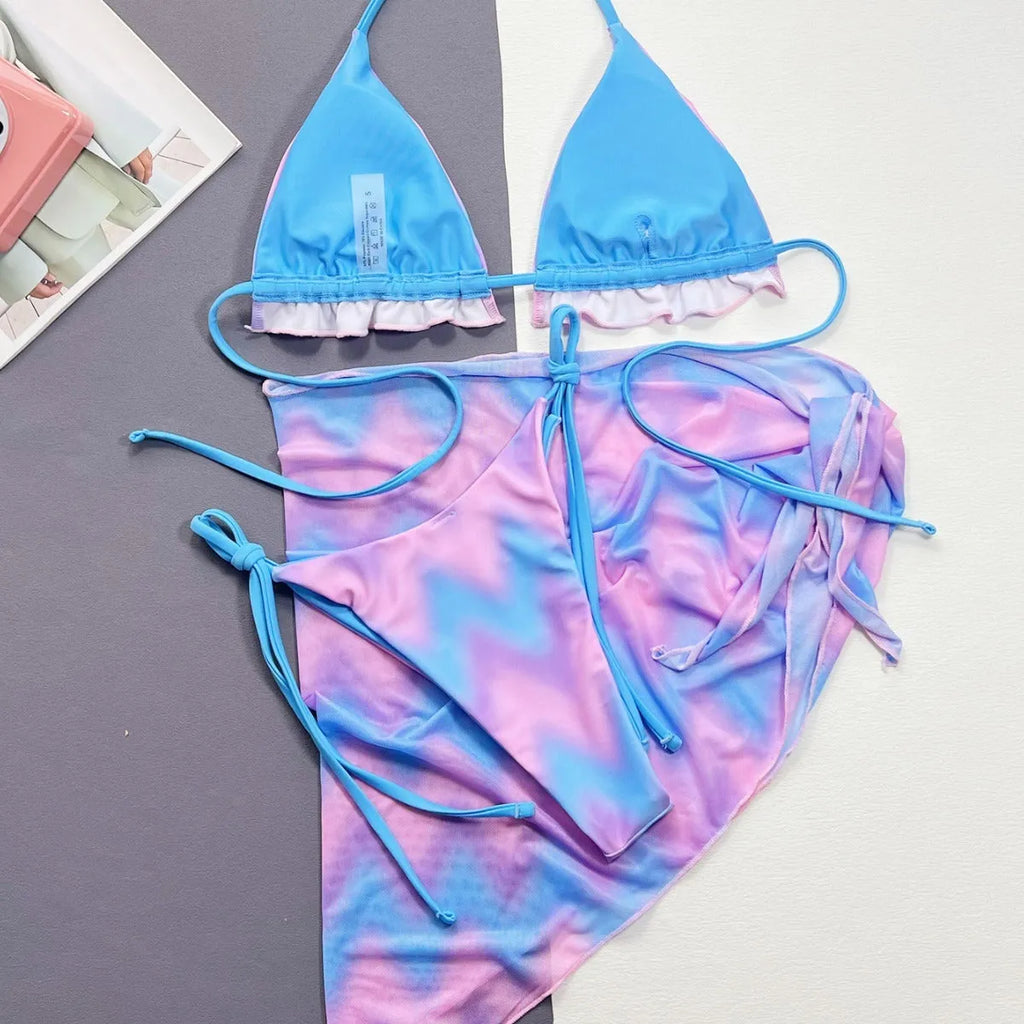 Women's tie-dye patterned bikini swimsuit with a removable skirt, showing bra top and briefs.