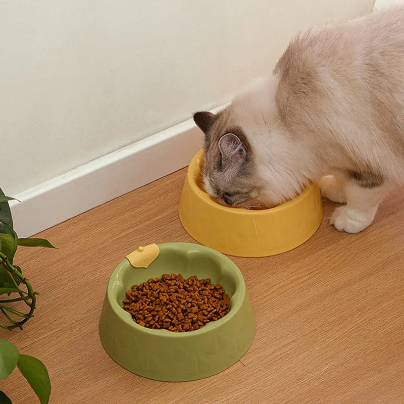 Flower-shaped green plastic double pet bowl for cat and dog food and water on a white surface.