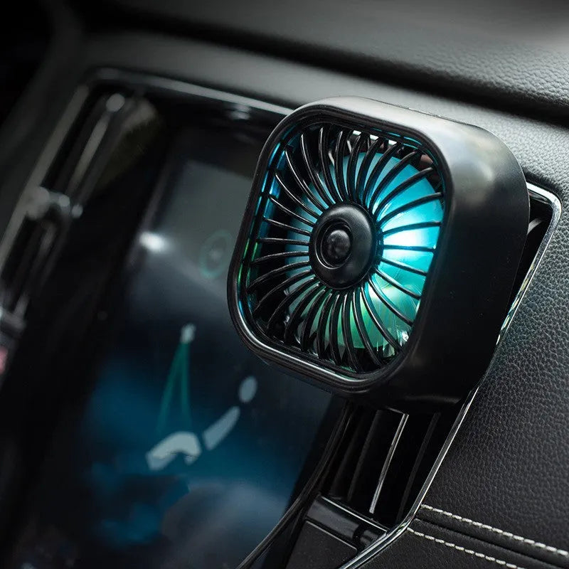 Black car USB fan mounted on vehicle air vent with three speed buttons and USB cable